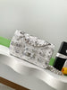Silver glittery Sequen Channel handbag on a white surface 